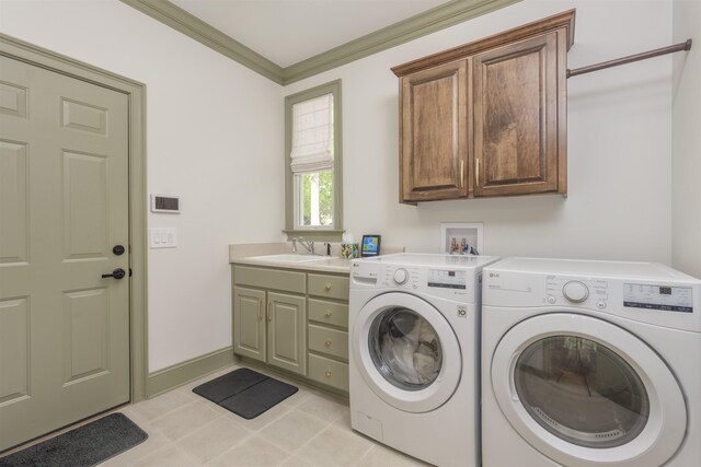 laundry area featuring light tile patterned flooring, sink, cabinets, independent washer and dryer, and crown molding