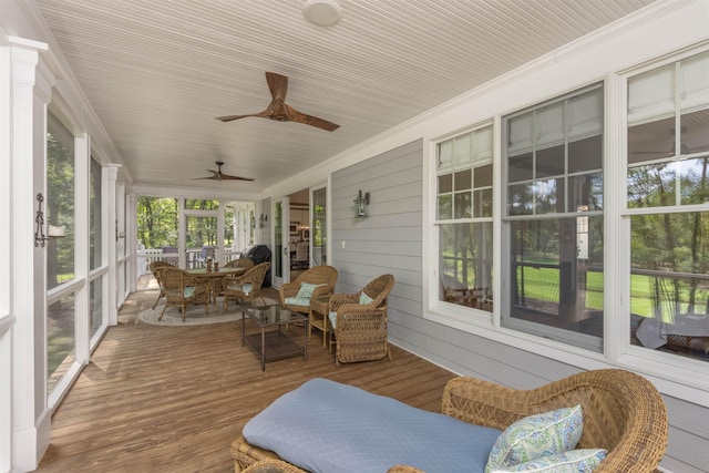 sunroom featuring ceiling fan