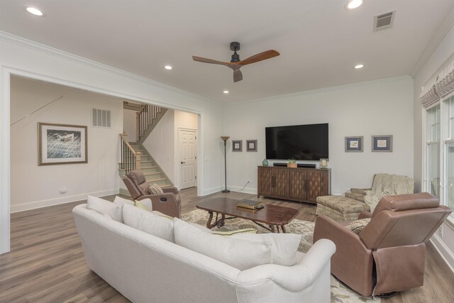 living room featuring crown molding, hardwood / wood-style floors, and ceiling fan