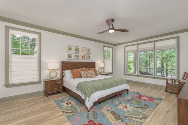 bedroom featuring crown molding, ceiling fan, and light hardwood / wood-style floors