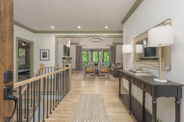 corridor featuring ornamental molding and light hardwood / wood-style floors