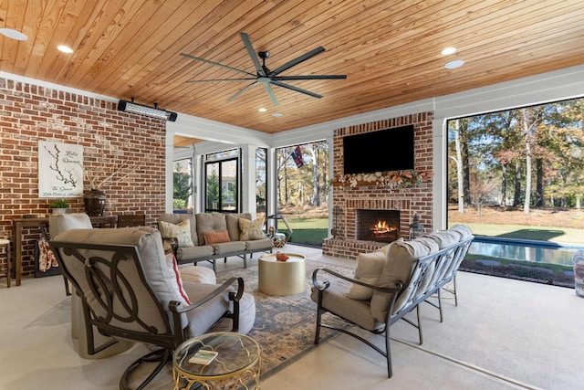 carpeted living room featuring wood ceiling, ceiling fan, brick wall, and an outdoor brick fireplace