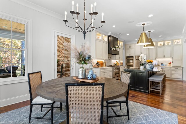 dining area with an inviting chandelier, ornamental molding, and dark hardwood / wood-style floors