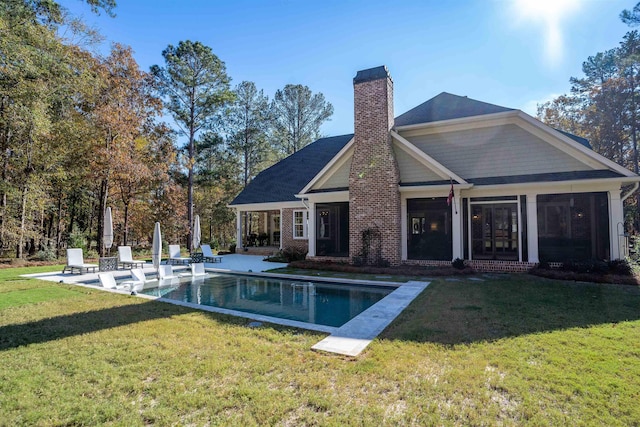 rear view of house with a patio and a yard