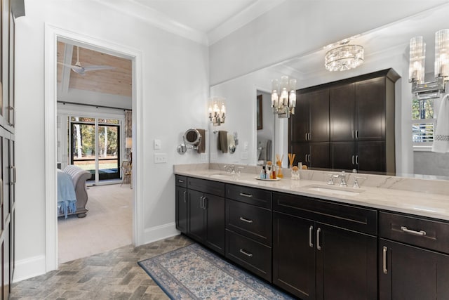 bathroom with crown molding and vanity