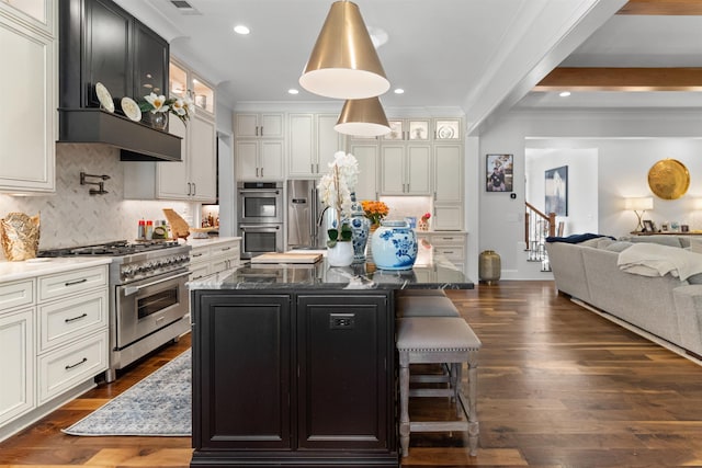 kitchen featuring high quality appliances, an island with sink, dark hardwood / wood-style floors, and dark stone counters