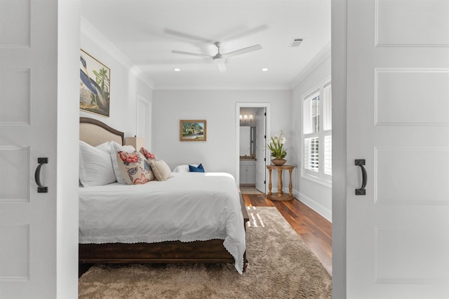 bedroom with connected bathroom, crown molding, wood-type flooring, and ceiling fan