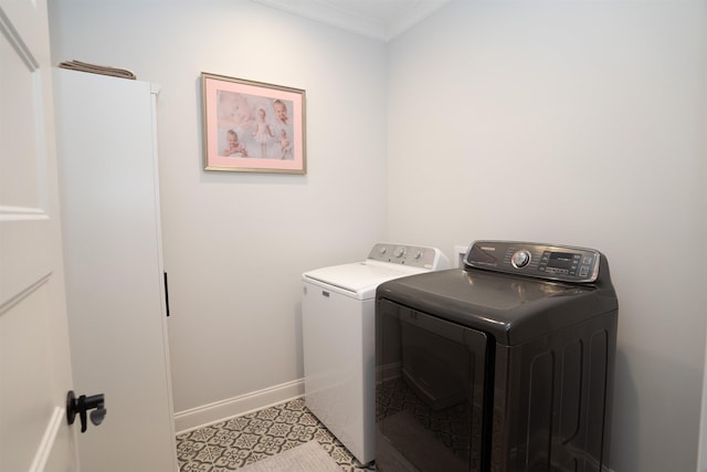 clothes washing area with crown molding and washer and dryer