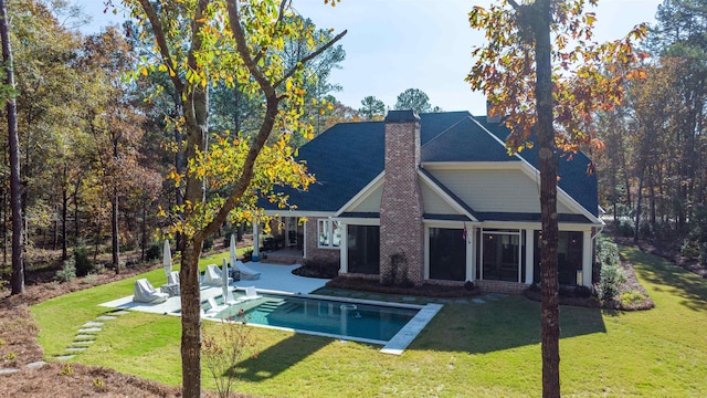 back of property featuring a patio and a yard