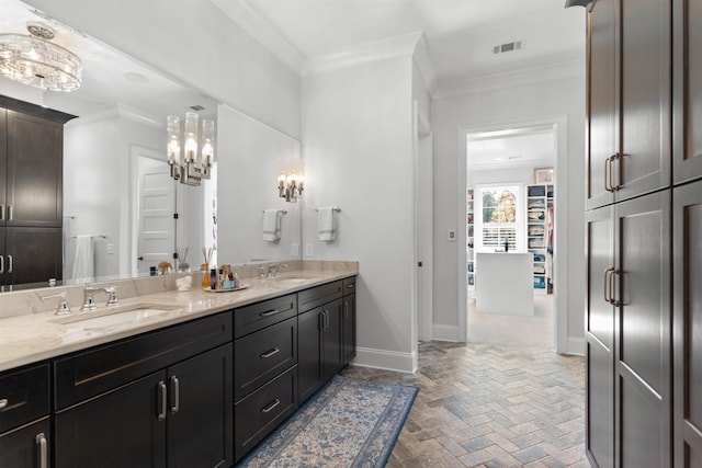 bathroom featuring crown molding and vanity