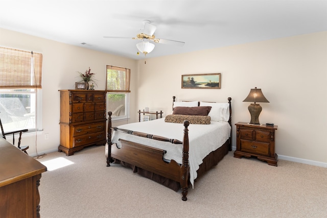 bedroom featuring light carpet and ceiling fan