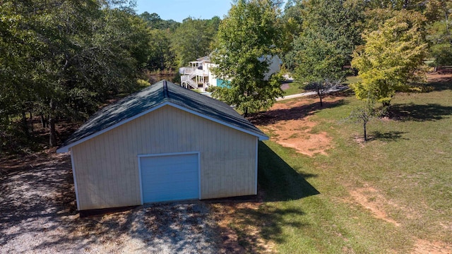 view of outbuilding featuring a garage and a yard