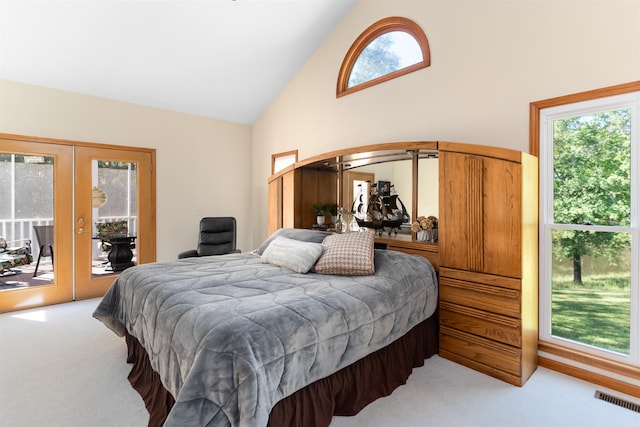 carpeted bedroom with french doors, high vaulted ceiling, multiple windows, and access to outside