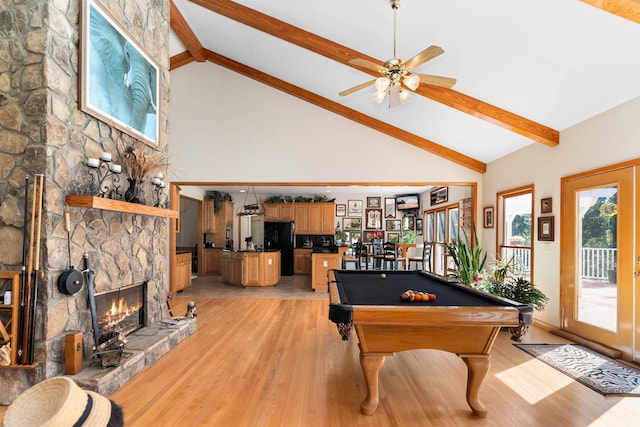 game room with pool table, a fireplace, beam ceiling, and light wood-type flooring