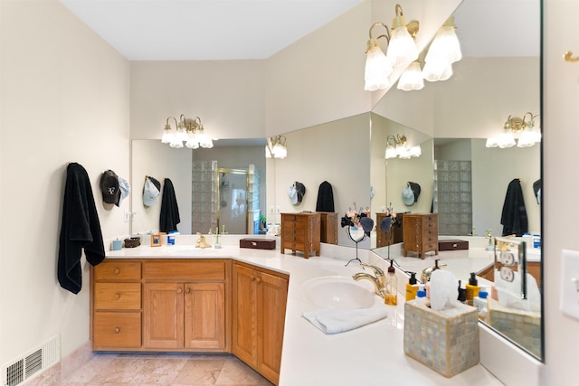 bathroom with vanity, an enclosed shower, and a chandelier