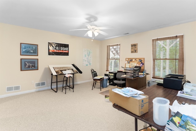 carpeted office space with ceiling fan