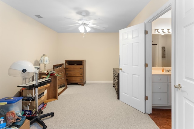 carpeted office space with ceiling fan