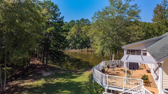 dock area featuring a deck with water view and a lawn