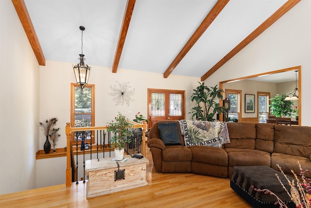 living room with lofted ceiling with beams and light hardwood / wood-style flooring