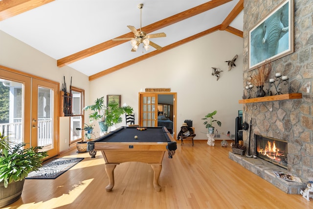 game room with billiards, a fireplace, wood-type flooring, french doors, and beamed ceiling