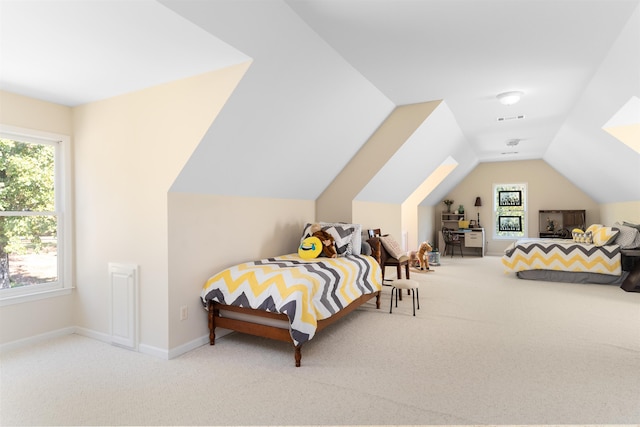 bedroom with vaulted ceiling and carpet flooring