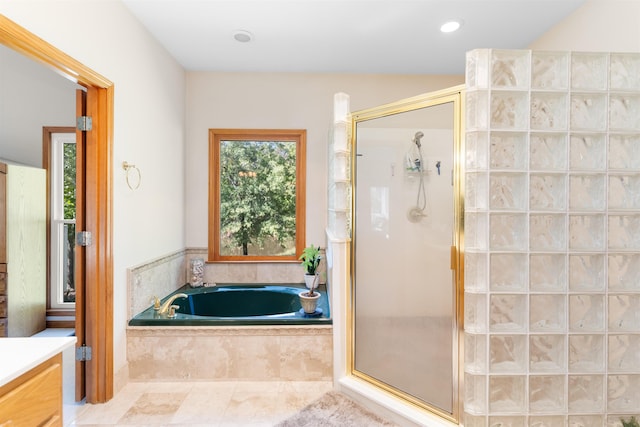 bathroom with shower with separate bathtub and vanity