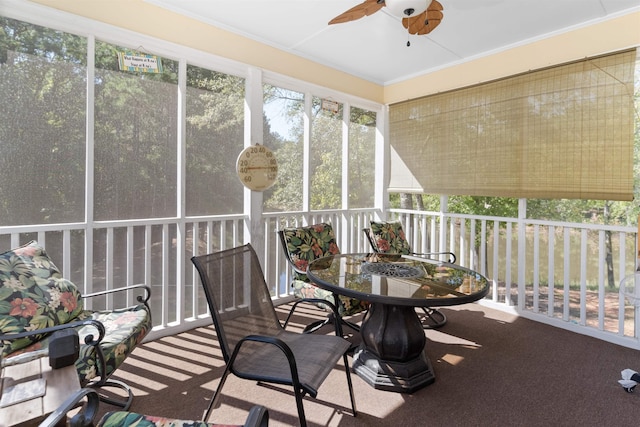 sunroom / solarium featuring ceiling fan