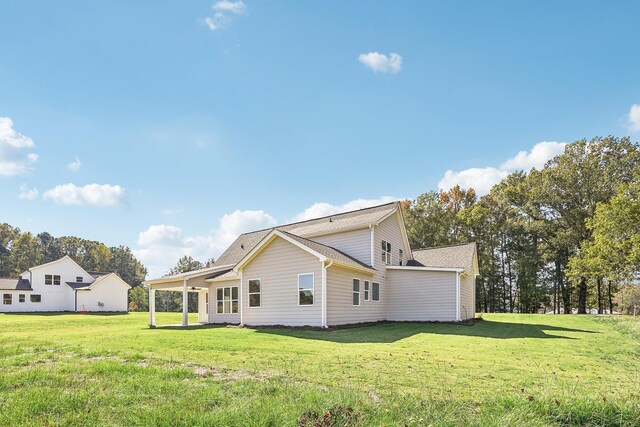 back of property featuring a lawn