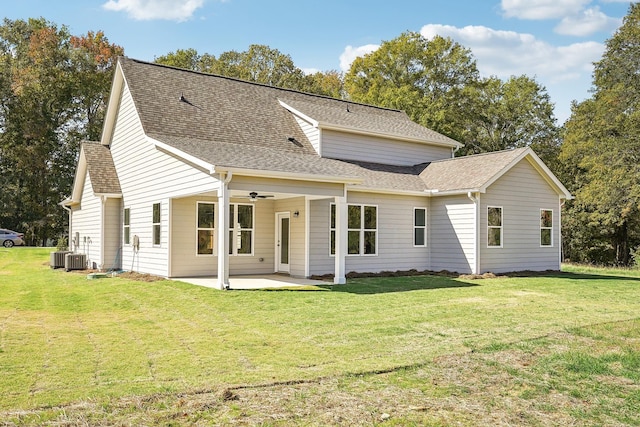 rear view of property with ceiling fan, a patio, and a lawn