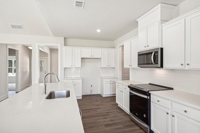 kitchen with sink, stainless steel appliances, dark hardwood / wood-style floors, and white cabinets