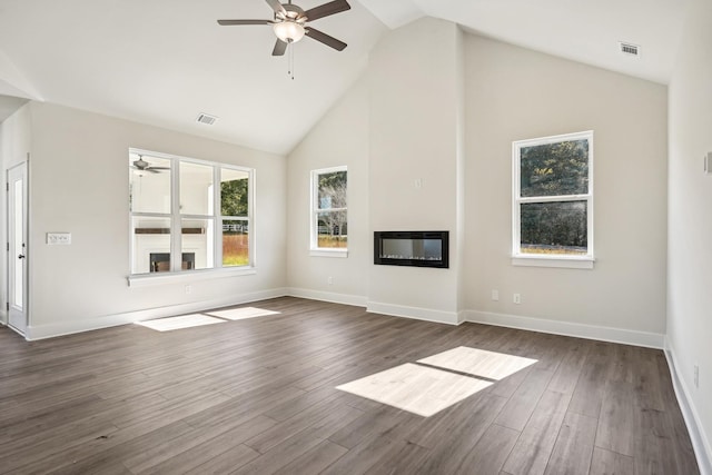 unfurnished living room featuring dark hardwood / wood-style flooring, high vaulted ceiling, and ceiling fan