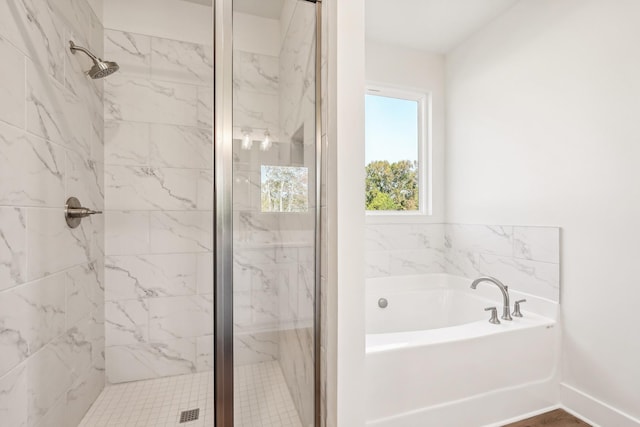 bathroom featuring separate shower and tub