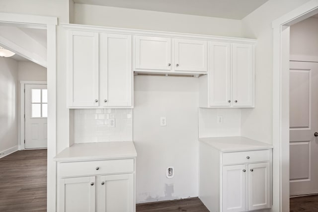 kitchen featuring white cabinetry, dark wood-type flooring, and backsplash