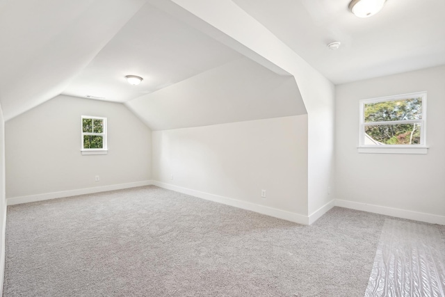 bonus room featuring lofted ceiling and carpet flooring