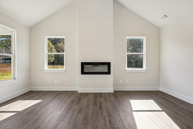 unfurnished living room featuring vaulted ceiling and dark hardwood / wood-style floors