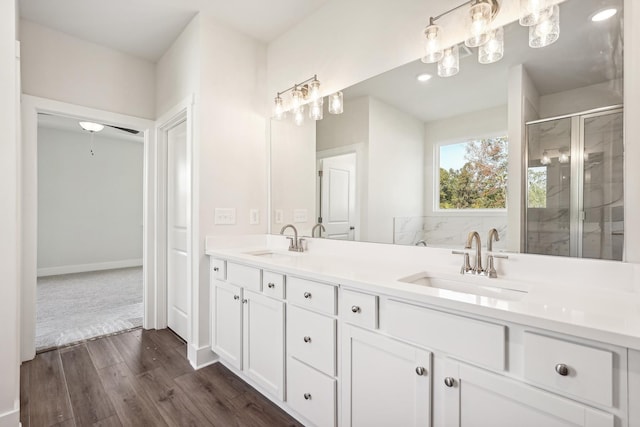 bathroom with independent shower and bath, vanity, and hardwood / wood-style floors