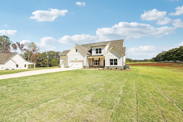 view of front of home featuring a garage, a front yard, and covered porch