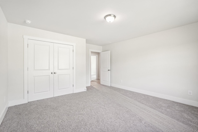 unfurnished bedroom with carpet floors and a closet