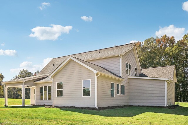 back of house with a lawn