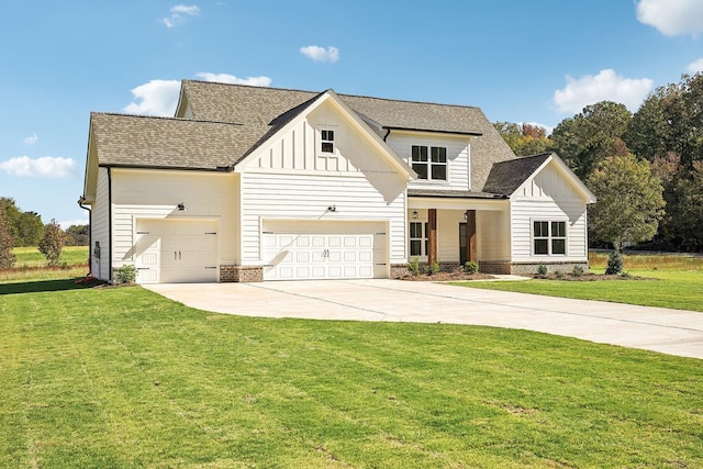 modern farmhouse featuring a garage and a front lawn