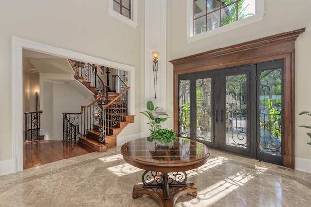 entrance foyer featuring french doors and a high ceiling