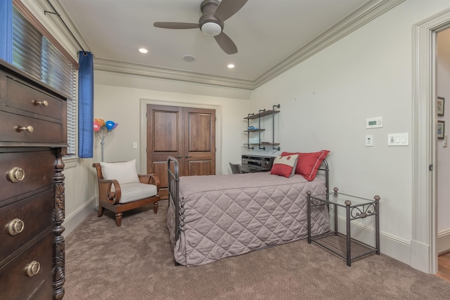 carpeted bedroom featuring crown molding and ceiling fan