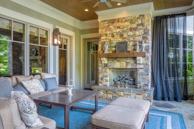 view of patio / terrace with ceiling fan and an outdoor stone fireplace