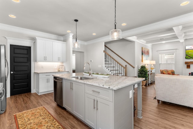 kitchen with sink, decorative light fixtures, dishwasher, a kitchen island with sink, and white cabinets