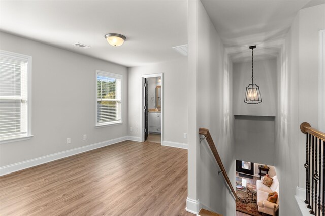 hallway with light hardwood / wood-style flooring