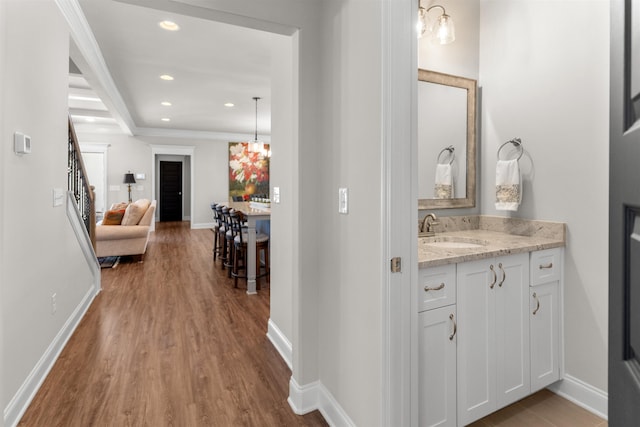 hall with sink and light hardwood / wood-style flooring