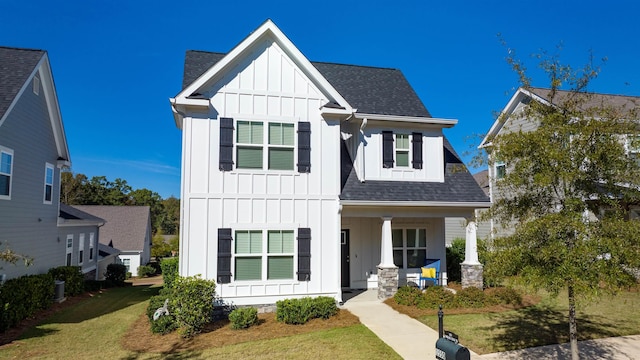 modern farmhouse featuring a front yard and covered porch