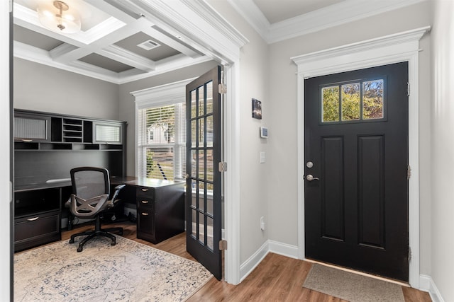 entrance foyer featuring beam ceiling, ornamental molding, coffered ceiling, and light hardwood / wood-style floors