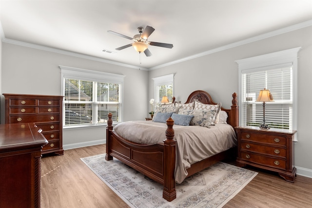 bedroom with ornamental molding and light hardwood / wood-style floors