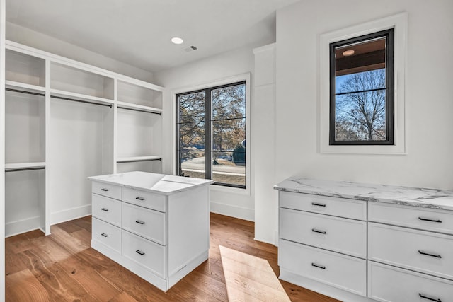 walk in closet featuring light wood finished floors and visible vents